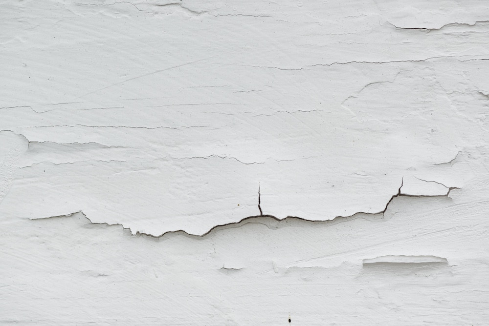 Cracked white paint on plank surface