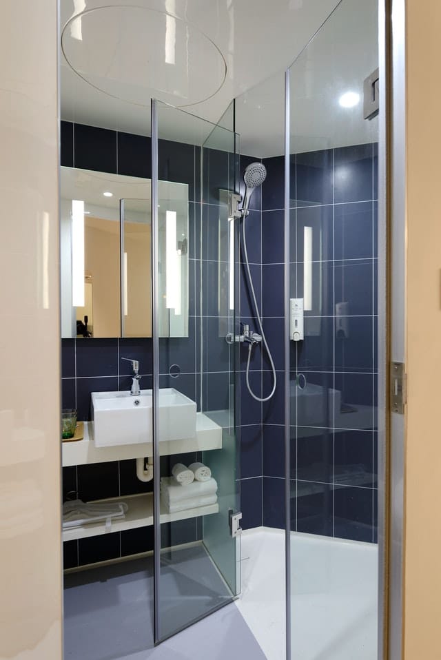 Modern Shower Room with Glass Panels and Blue Tiles