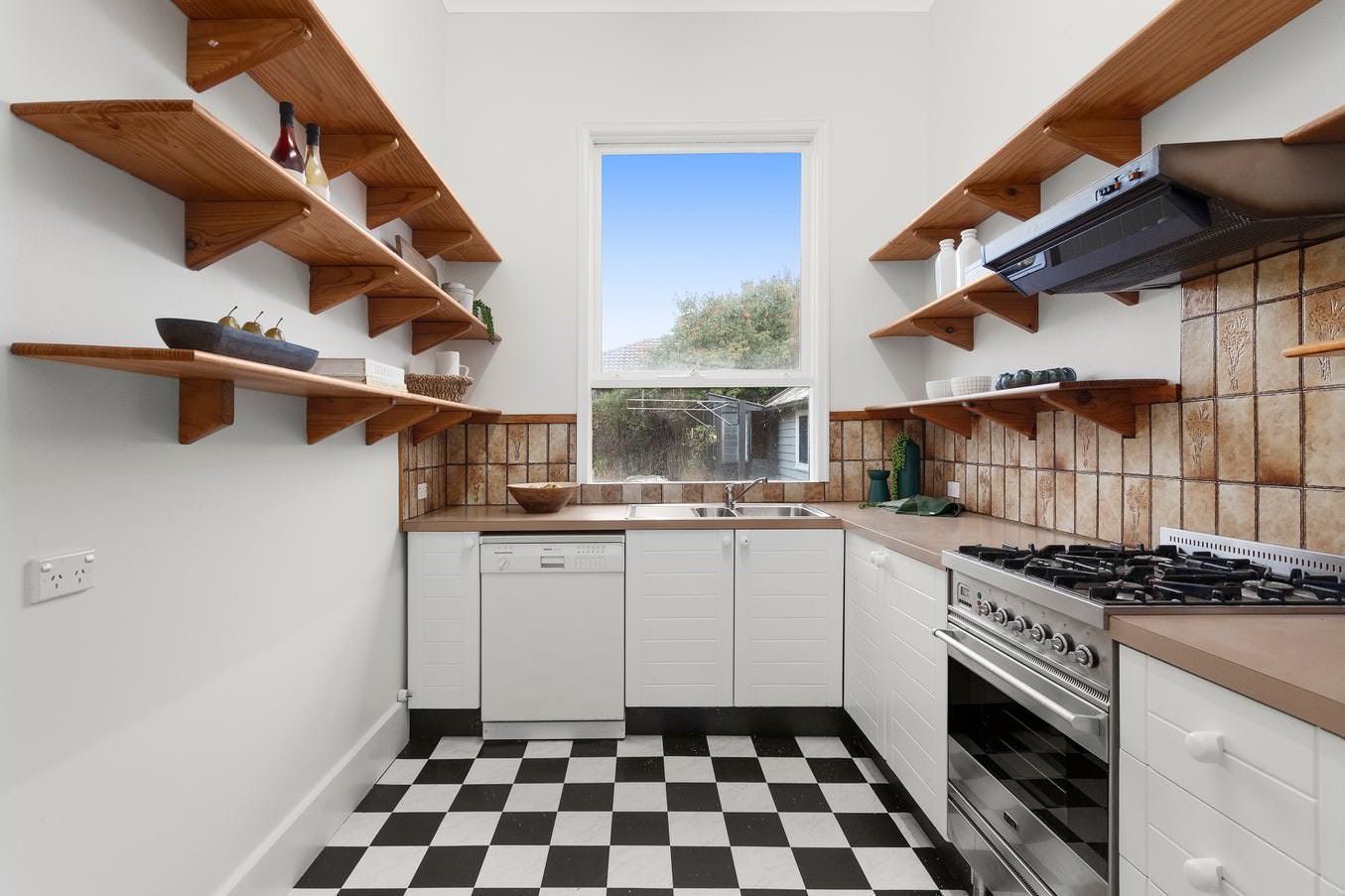 Retro-Inspired Kitchen With Open Wooden Shelving and Checkered Flooring