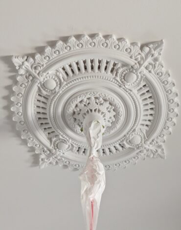 Original plaster ceiling rose repainted white in a period home on Elm Street, Flemington