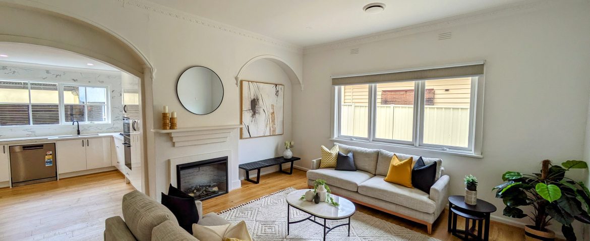 Modern Living Room with a Fireplace, Abstract Art, and Decorative Sofa