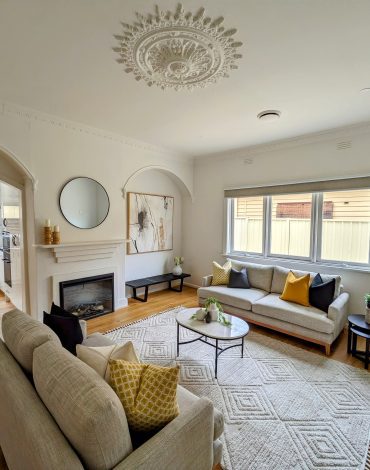 Modern Living Room with a Fireplace, Abstract Art, and Decorative Sofa