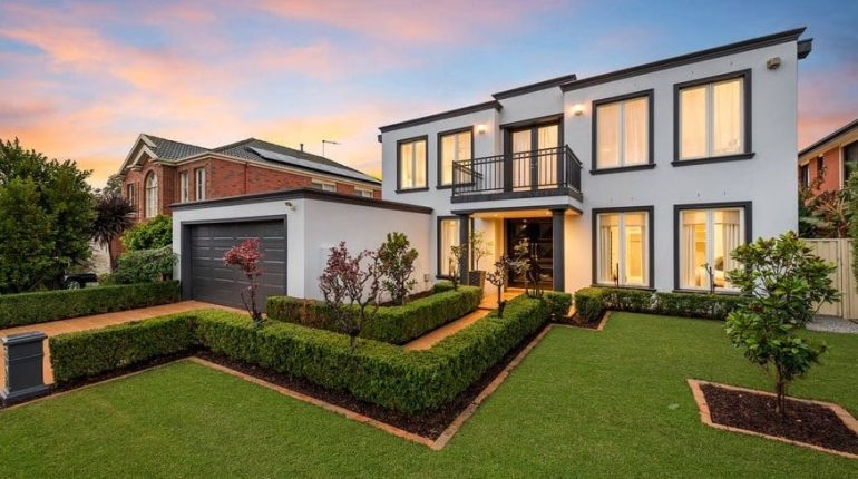 Modern Two-Story House With Fresh Exterior Paint and Elegant Landscaping