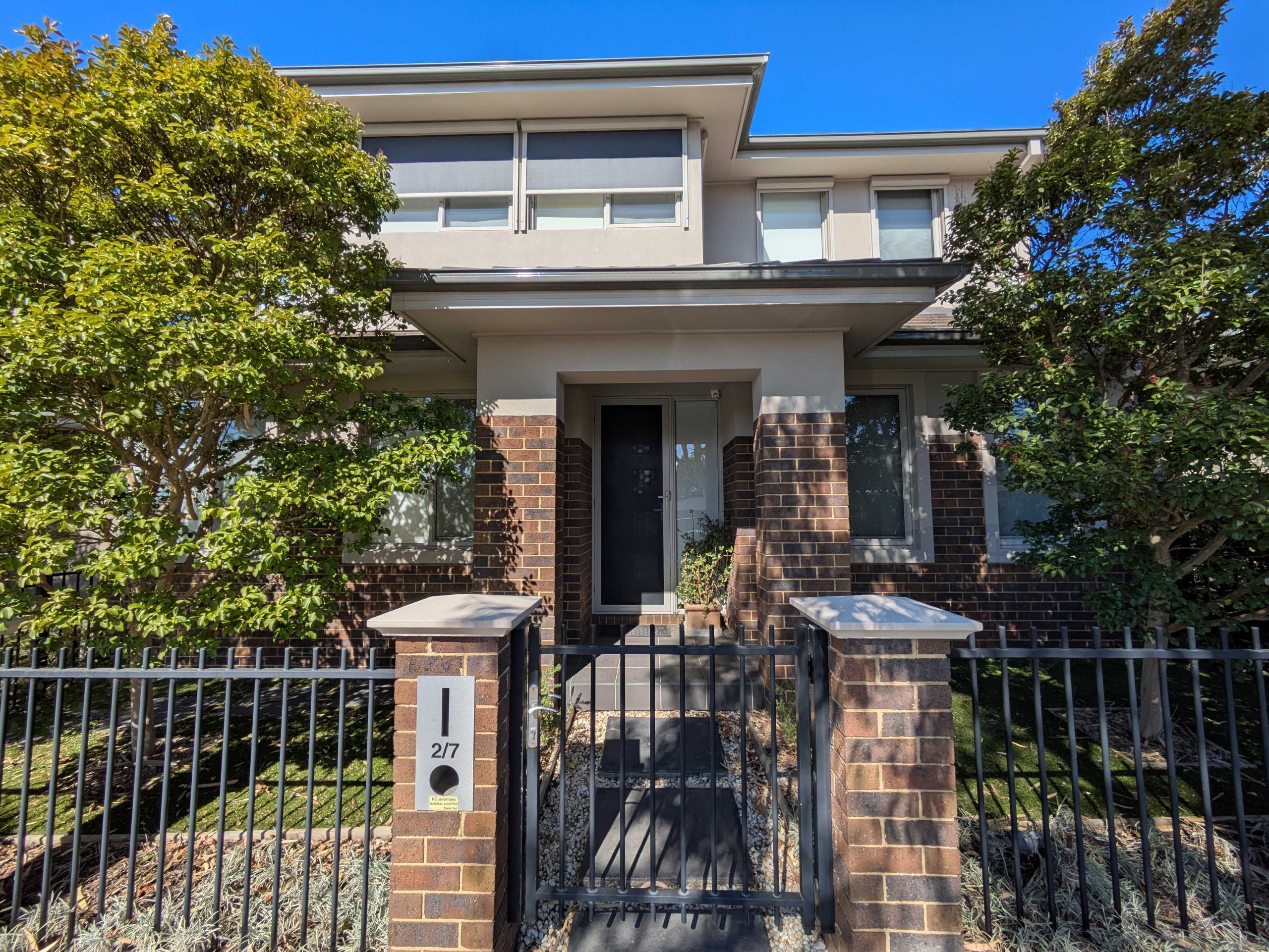Modern Two-Story Home Exterior with Brick and Neutral-Tone Finishes