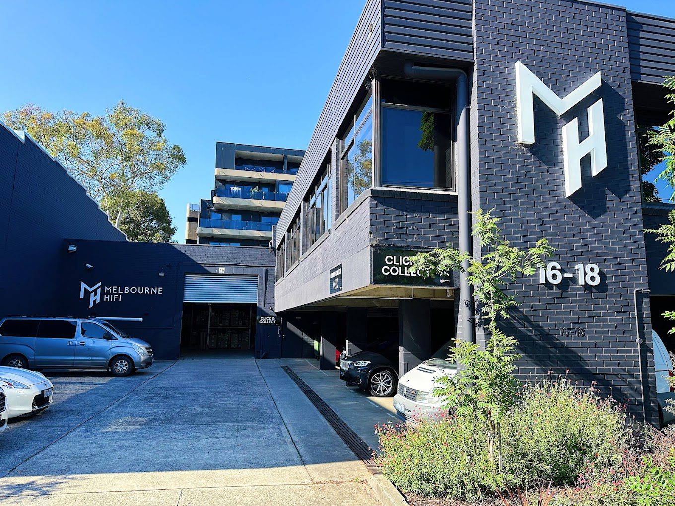 Modern Commercial Building with Dark Grey Brick Exterior and Melbourne HiFi Signage
