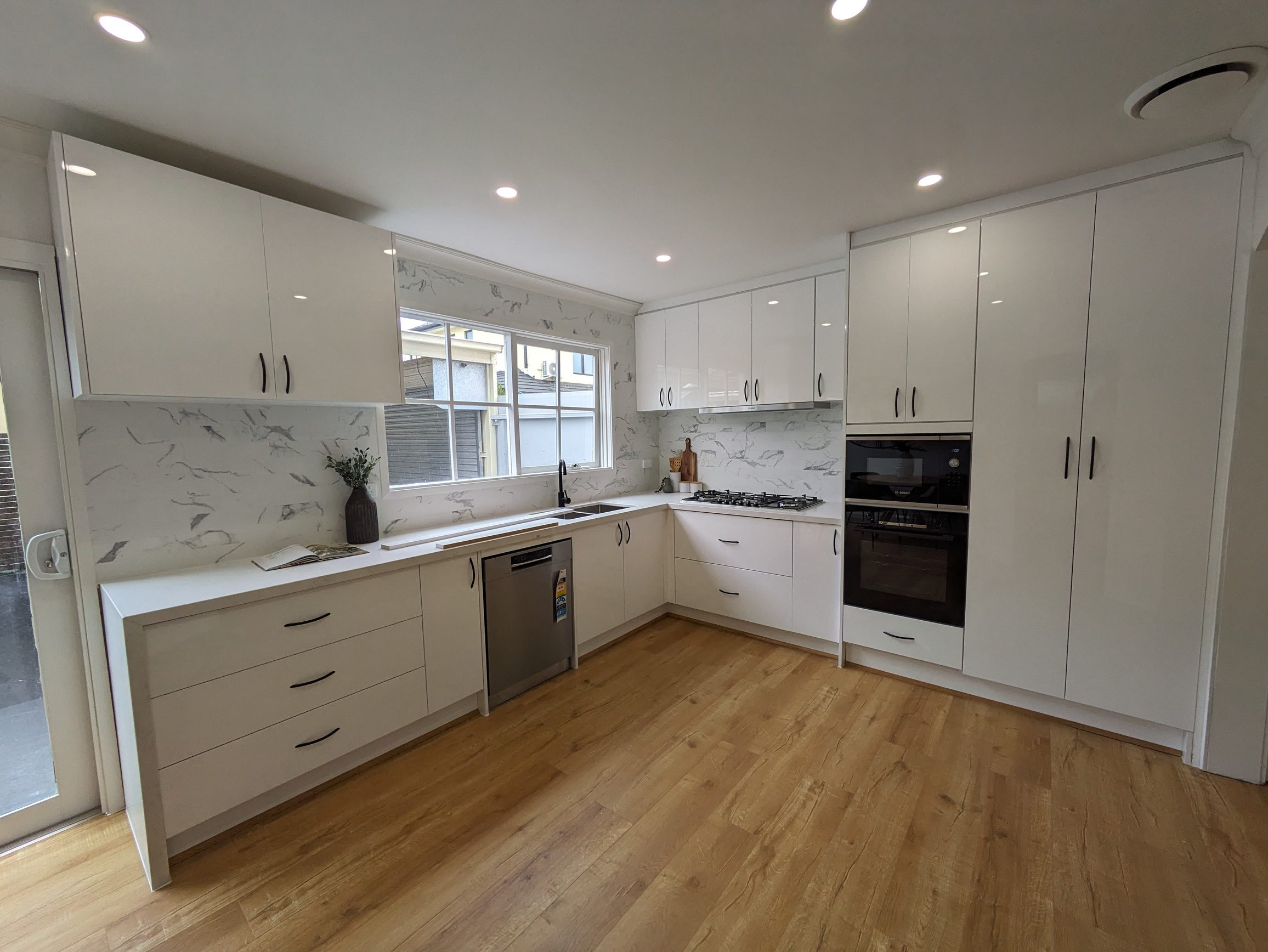 Modern Kitchen with White Cabinets and Marble Backsplash