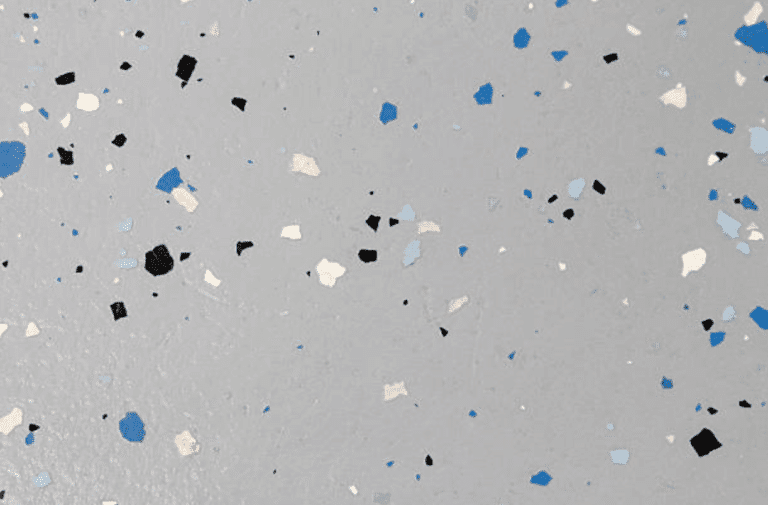 Gray epoxy floor with blue, black, and white decorative flakes.