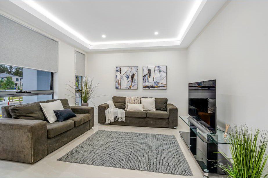 Elegant living room with neutral interior painting, modern furnishings, and ambient lighting.