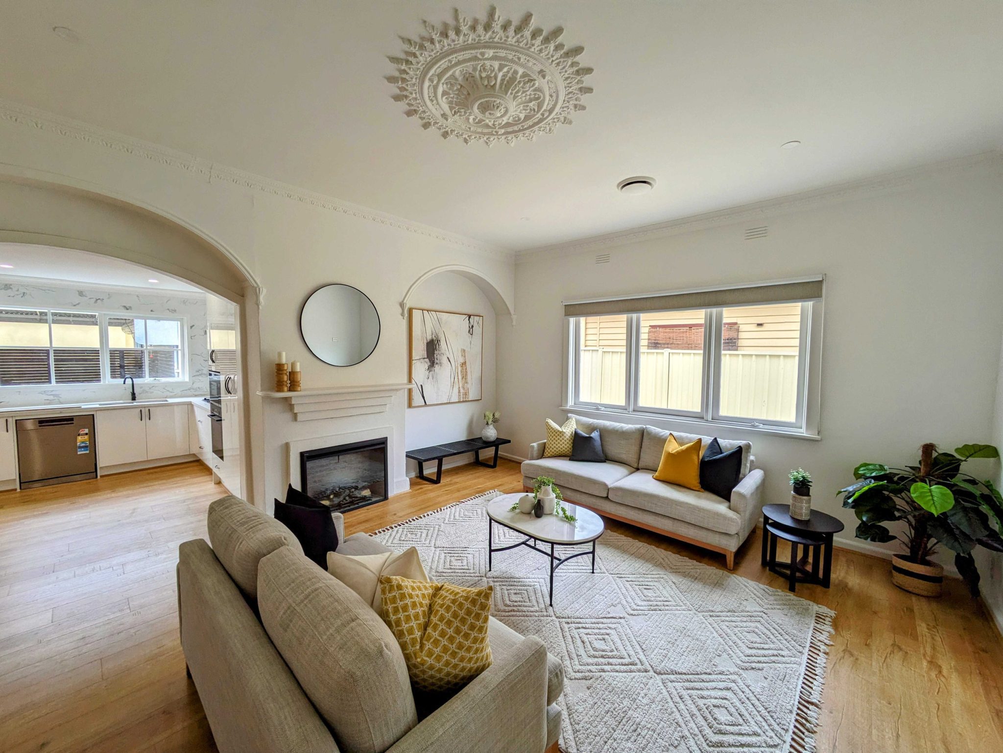 Bright and spacious living room with modern décor, fireplace, and comfortable seating
