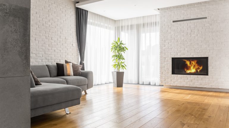 Modern Living Room with White Brick Walls, Fireplace, and Grey Sofa