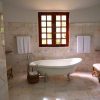 Luxury bathroom with a freestanding bathtub, marble tiles, and elegant décor.