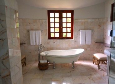 Luxury bathroom with a freestanding bathtub, marble tiles, and elegant décor.