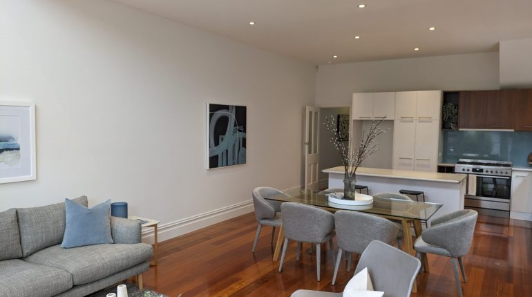Modern Open-Plan Living and Dining Area with Neutral Decor and Wood Floors
