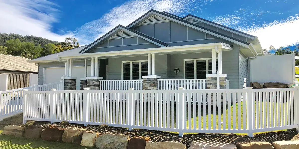 Charming Home with a Freshly Painted Exterior and White Fencing