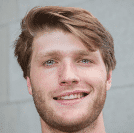 A young man with light brown hair and a friendly smile.
