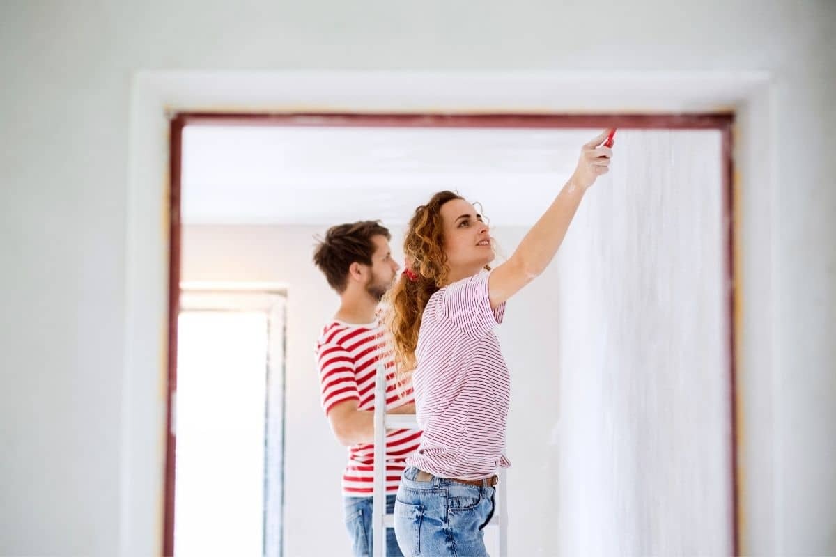 couple paints interior room together