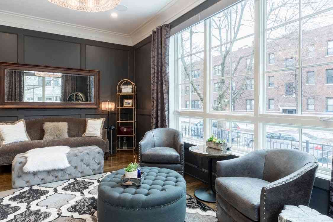 Using a dark grey panelling to match a living room with big windows