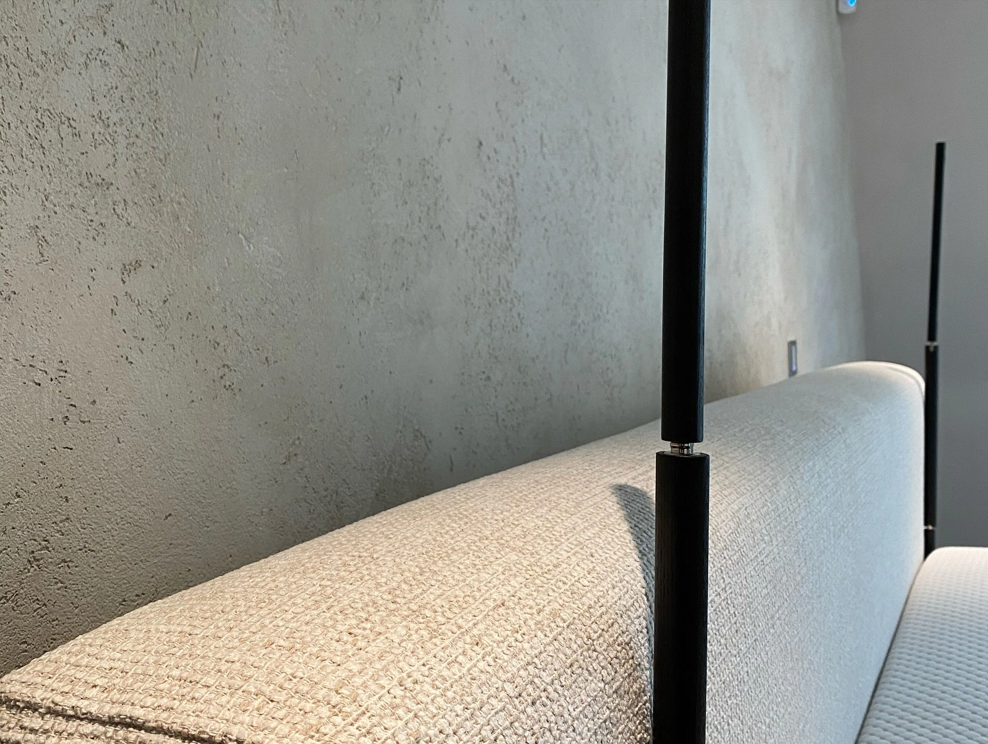 Professional venetian plaster wall finish by Newline Painting featuring textured concrete-look surface with modern furniture